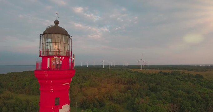 Girls dancing at the top of the red lighthouse pakri