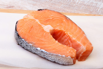 fresh raw salmon with spices on wooden cutting board. ready for cookin