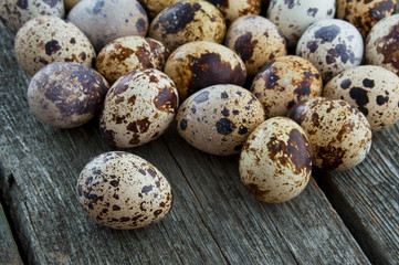 Quail eggs on a wooden background.