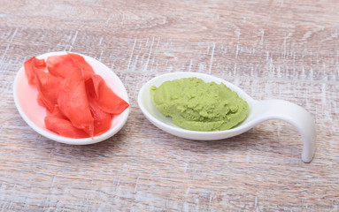 Bowl with Wasabi and ginger on wooden background. Japanese cuisine. Asia food.
