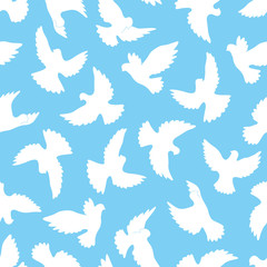 Fototapeta na wymiar White doves seamless pattern on a blue background.