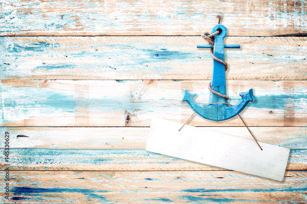 Wall mural vintage anchor on old wooden background with blue paint . vintage wood texture from beach in summer.