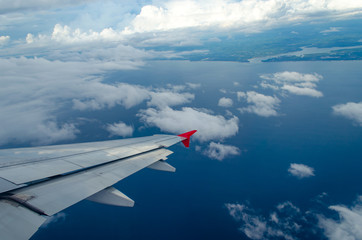 Fototapeta premium Beautiful Blue Sky Background and White Cloud by Take a Picture Through Window of an Aircraft during Flight in Wing.