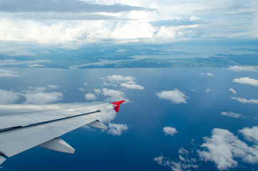 Fototapeta premium Beautiful Blue Sky Background and White Cloud by Take a Picture Through Window of an Aircraft during Flight in Wing.