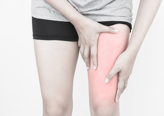 Young woman massaging her painful thigh muscles from exercising and running.
