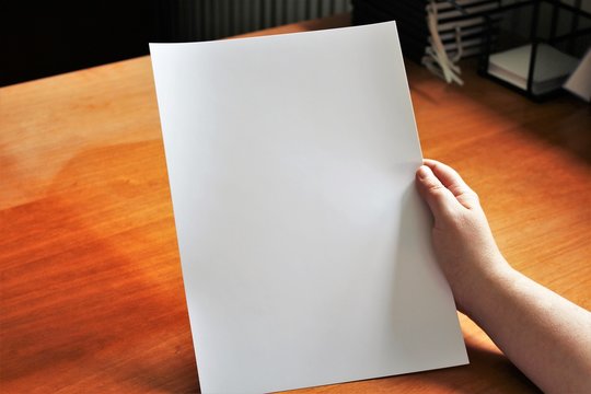 A image of a hand, or hands with paper