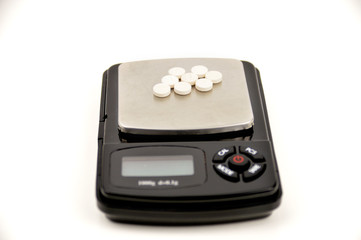 pills on digital scale