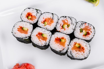 Asia. Rolls with salmon (red fish) on a white plate on a white background