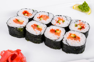 Asia. Rolls with salmon (red fish) on a white plate on a white background