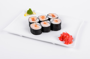 Asia. Spicy rolls with salmon (red fish) on a white plate on a white background