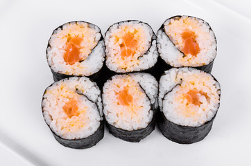 Asia. Spicy rolls with salmon (red fish) on a white plate on a white background