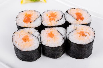 Asia. Spicy rolls with salmon (red fish) on a white plate on a white background