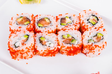 Asia. California rolls with salmon (red fish) on a white plate on a white background