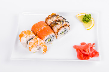 Asia. Tokyo rolls with shrimp, eel and salmon on a white plate on a white background