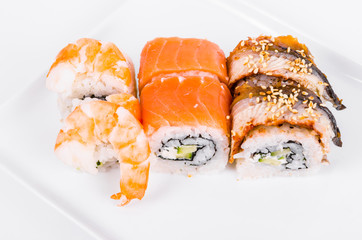 Asia. Tokyo rolls with shrimp, eel and salmon on a white plate on a white background