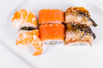 Asia. Tokyo rolls with shrimp, eel and salmon on a white plate on a white background