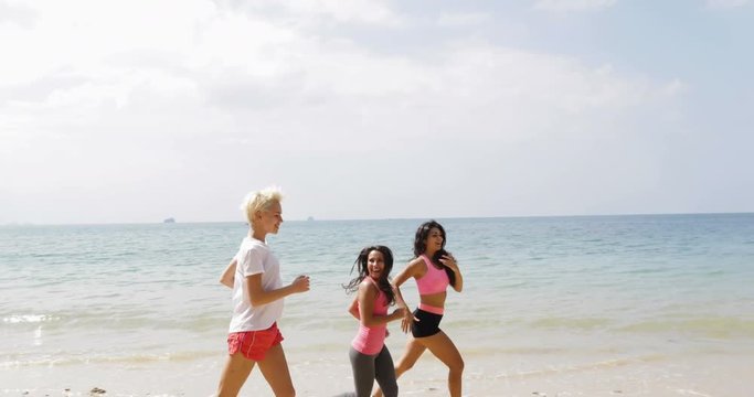 Girls Group Running On Beach Young Women Jogging Training Outdoors Exercising On Seaside Working Out Slow Motion 60