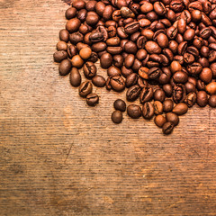 Coffee beans on a grunge wooden background