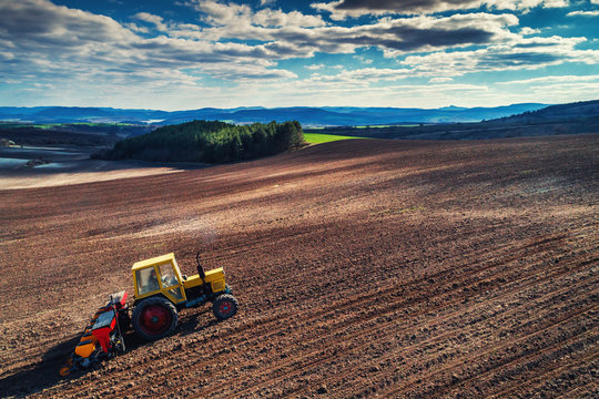 Aerial view of tractor working on the harvest field