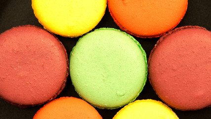 Top view of a Colorful Macaroons on a black table