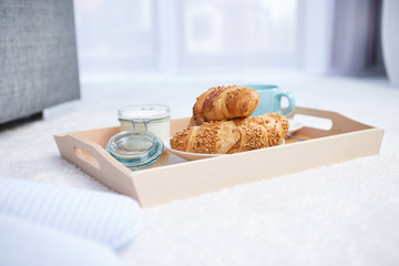 breakfast in bed with coffee and croissants