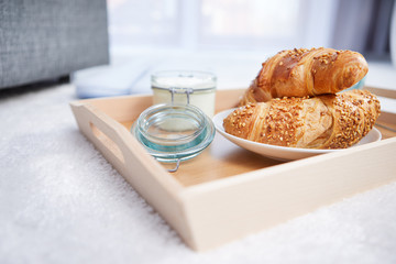 breakfast in bed with coffee and croissants