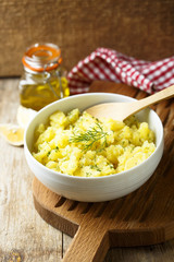 Potato salad with fresh dill in white bowl