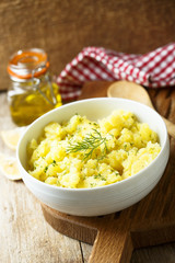 Potato salad with fresh dill in white bowl