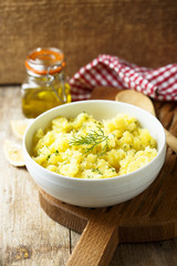 Potato salad with fresh dill in white bowl