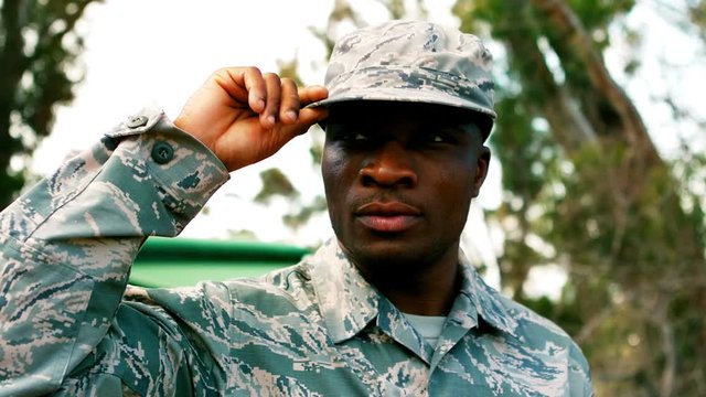 Military man holding his cap