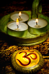 Om symbol on a stone with three candles like a oriental buddhism spiritual  meditation reiki chakra...