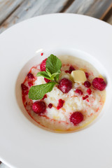 Boiled rice with raspberry in a large plate