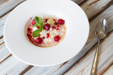 Boiled rice with raspberry in a large plate