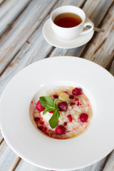 Boiled rice with raspberry in a large plate