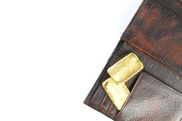 Gold bar put in the leather wallet represent business concept.