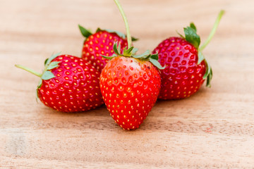 red close up strawberries with selective focus on a strawberry with many strawberries