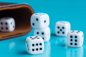 White gambling cubes in the blue backround.