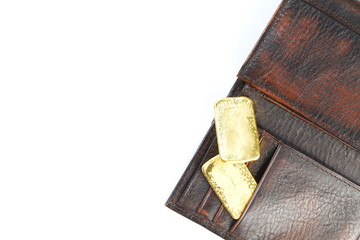 Gold bar put in the leather wallet represent business concept.
