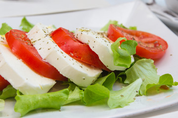 Salad Caprese, a combination of tomatoes, mozzarella and basil, is similar to the Italian flag selective focus