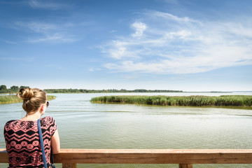 Fototapeta premium Tourist at lake pier