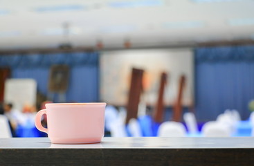 coffee cup pink in seminar conference room background. select focus with shallow depth of field