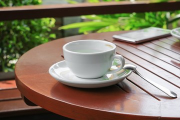 coffee cup on the wood floor background