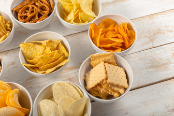 Pretzels in bowls on wooden table from above