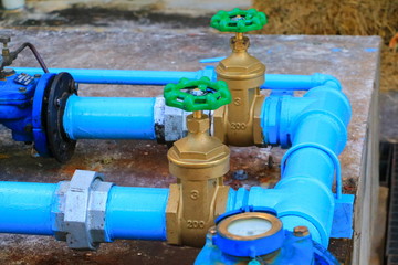 Fototapeta na wymiar water valve plumbing joint steel tap pipe with green knob close up