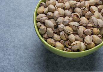 Pistachio nuts in a green plate