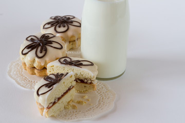Biscuit decorative cookies with jam and glaze, with  milk on white background
