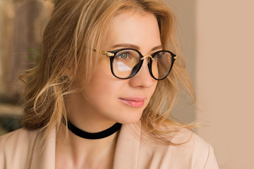 Portrait of a beautiful girl in glasses close-up, Portrait of a blonde with elegant styling