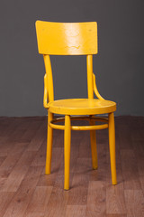 Yellow chair in room with wooden floor