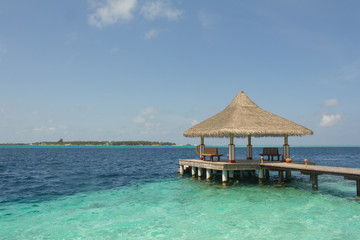 Wooden pier on a tropical beach in the Maldives