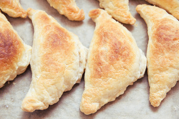 Toasted home-made pies from puff pastry.